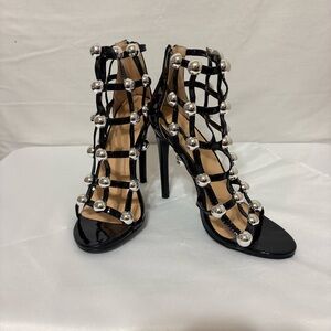 Yoki black patent leather strappy sandals.